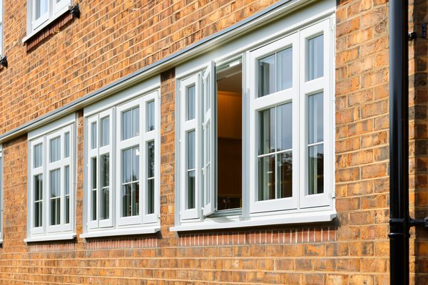 White casement windows on a brick home
